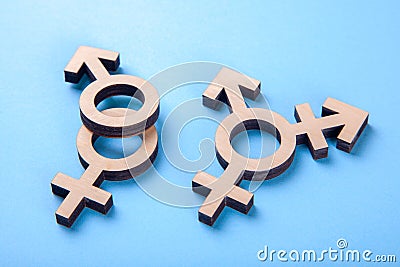 Symbol of transgender and gender symbols of man and woman of tree on blue Stock Photo