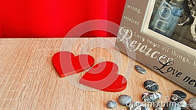 Symbol for valentine's day. two wooden hearts, gray pebbles, a gray photo frame Stock Photo