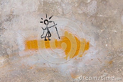 Symbol of the Way of Saint James, or Camino de Santiago, with a yellow arrow and a pilgrim on it Stock Photo