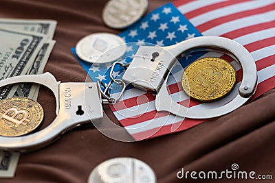Symbolic coins of bitcoin and stack of bitcoin coins and metall handcuffs on banknotes of one hundred dollars. Exchange Stock Photo