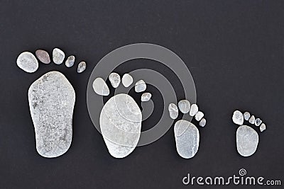 Symbolic lime stones forming stone foots of parents and two kids Stock Photo