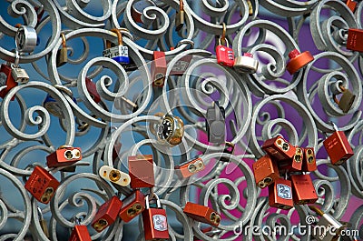 Symbolic Multiple Colorful Locks on a Metal Fence Editorial Stock Photo