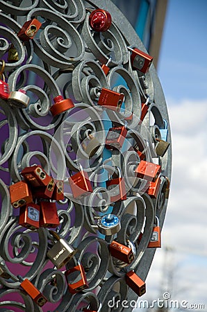 Symbolic Multiple Colorful Locks on a Metal Fence Editorial Stock Photo