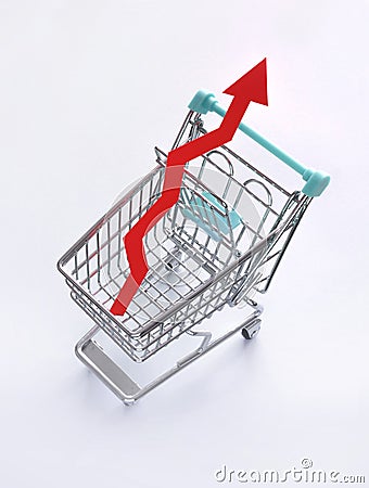 Symbolic Representation of Inflation, Rising Prices and the High Cost of Living. Red Rising Arrow in a Shopping Cart. Stock Photo