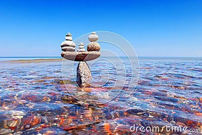 Symbolic scales of standing stones in the water. The concept of balance. Stock Photo