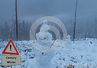 Sign Century Winter in Front of Snowman Stock Photo