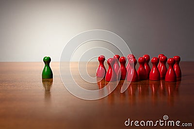 Symbolism wooden red and green figures for business exclusion racism mobbing hate religions Stock Photo
