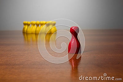 Symbolism wooden red and yellow figures for business exclusion racism mobbing hate religions Stock Photo