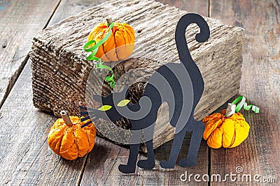 Symbols of Halloween: a black cat and a pumpkin made of paper Stock Photo