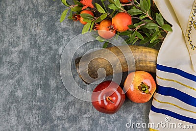 Symbols of the Jewish New Year with a shofar, honey jar, fresh apples pomegranates on Rosh Hashanah Stock Photo