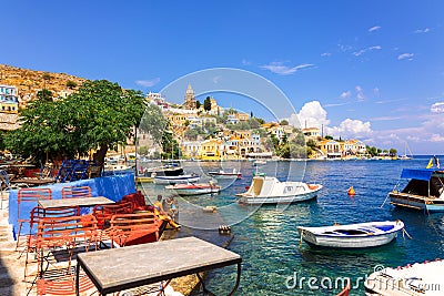 Panoramic view, aerial skyline of small haven of Symi island. Village with tiny beach and colorful houses located on Editorial Stock Photo