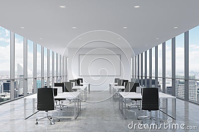 A symmetric corporate workplaces equipped by modern laptops in a modern panoramic office in New York City. Stock Photo