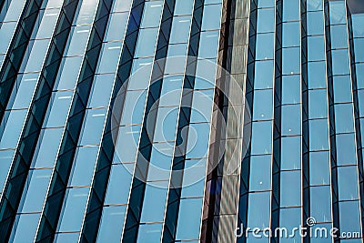 Symmetrical Geometric Glass Pattern on Skyscraper Stock Photo