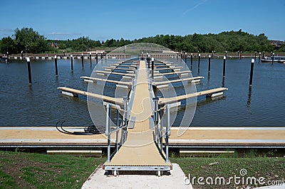 Symmetrical pattern of pontoons and piles in an empty boat marina Stock Photo