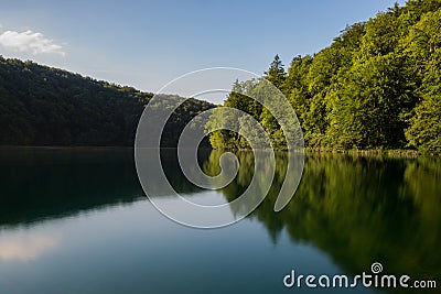A croatian lake surrounded by trees at dusk Stock Photo