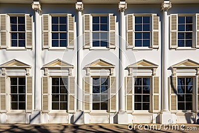 symmetrical windows in sunlight on greek revival building Stock Photo