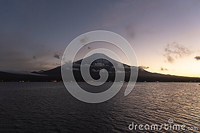 Symmetry snowcapped volcano mountain Fuji against Yamanakako famous tourist lake Stock Photo