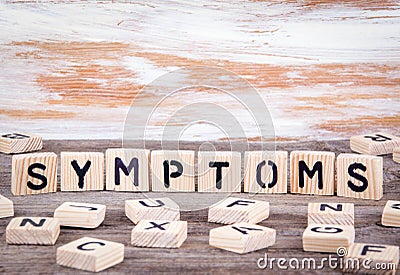 Symptoms from wooden letters on wooden background Stock Photo