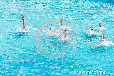 Synchronised swimming. Beautiful lean female legs in the water of a swimming pool. Concept of beauty, artistry Stock Photo