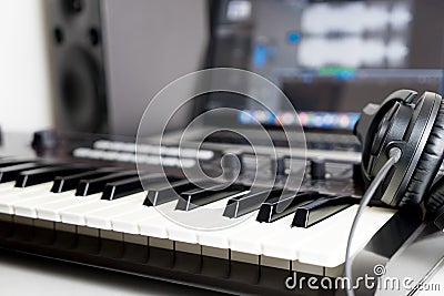 Synthesizer keyboard and headphone lying on Music studio Stock Photo