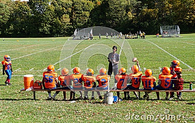Syracuse, New York, U.S - October 15, 2022 - The little kids football players on the field with their coach Editorial Stock Photo