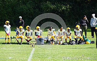 Syracuse, New York, U.S - October 15, 2022 - The little kids football players on the field with their coach Editorial Stock Photo