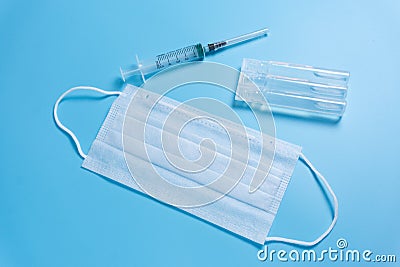 Syringe, ampule and medical face mask Stock Photo