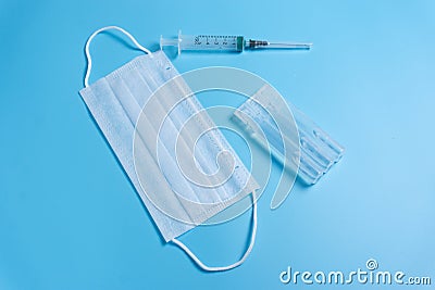 Syringe, ampule and medical face mask Stock Photo