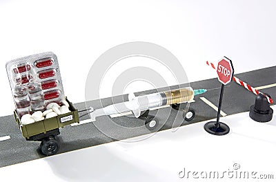 Syringe with doping is riding on the road with trailer full of pills, but can not cross the stop sign and a barrier. Stock Photo