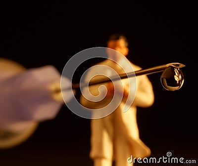 Syringe with drop and figurine Stock Photo