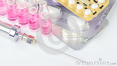 Syringe with glass vials and medications pills Stock Photo