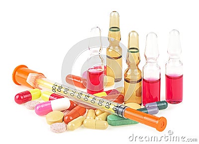 Syringe with glass vials and medicinal tablets and pills isolated on a white background. Stock Photo