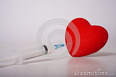 Syringe laid in the form of heart Stock Photo