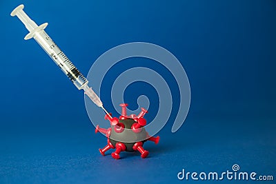 Syringe with liquid medicine shot to corona virus cell minimal creative concept. Space for copy Stock Photo