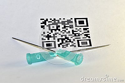 The syringe needles are stuck in the QR-code Stock Photo