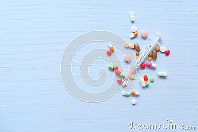 Syringe and pills on white background, top view Stock Photo