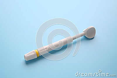 Syringe of resin luting cement on color background Stock Photo