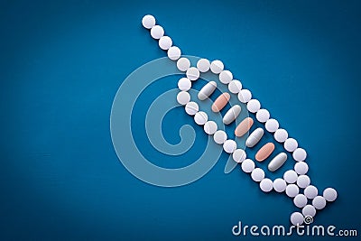 Syringe shape made of pills and vitamin Stock Photo