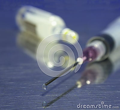Syringe, sharp needle and ampule Stock Photo