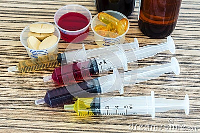 Syringe with syrup medicine and pill use to feed for kids Stock Photo