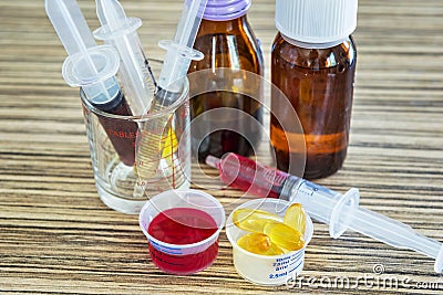 Syringe with syrup medicine and pill use to feed for kids. Stock Photo