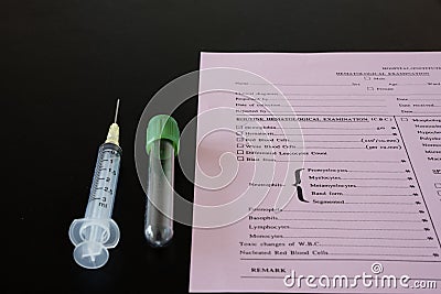 A syringe, testtube, and laboratory request Stock Photo