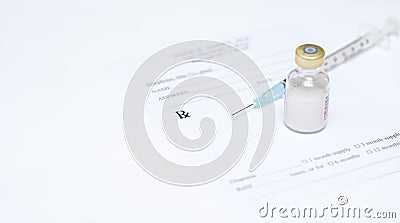 Syringe and vile on prescription pad Stock Photo