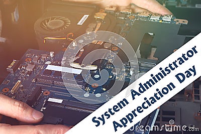 System Administrator Appreciation Day. Postcard for the holiday. The guy is fixing the laptop. Stock Photo