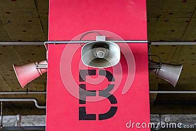 System of alert for population. Mounted on concrete poles under the ceiling of a building to inform an organization or community. Stock Photo