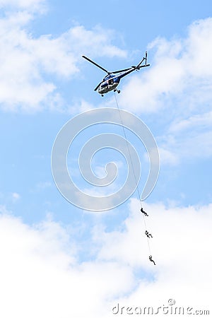 Szczecin, Poland, June 12, 2017: Police helicopter, rescue action with people on a line. Editorial Stock Photo