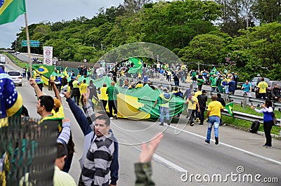 Several patriots protesters open the green and yellow flag on the road dutra BR-116 Editorial Stock Photo