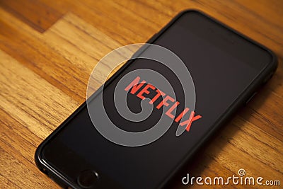 Leading platform in the movie streaming segment, netflix with the application open on a cell phone. Editorial Stock Photo