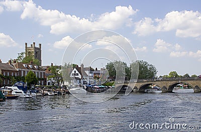 St Mary's Church of England tower overlooking the Thames with its boats and barge Editorial Stock Photo