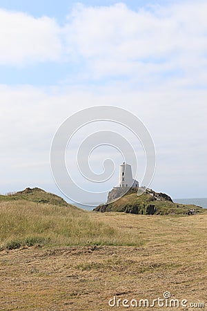 TÅµr Mawr lighthouse, on Ynys Llanddwyn on Anglesey, Wales, marks the western entrance to the Menai Strait. Editorial Stock Photo